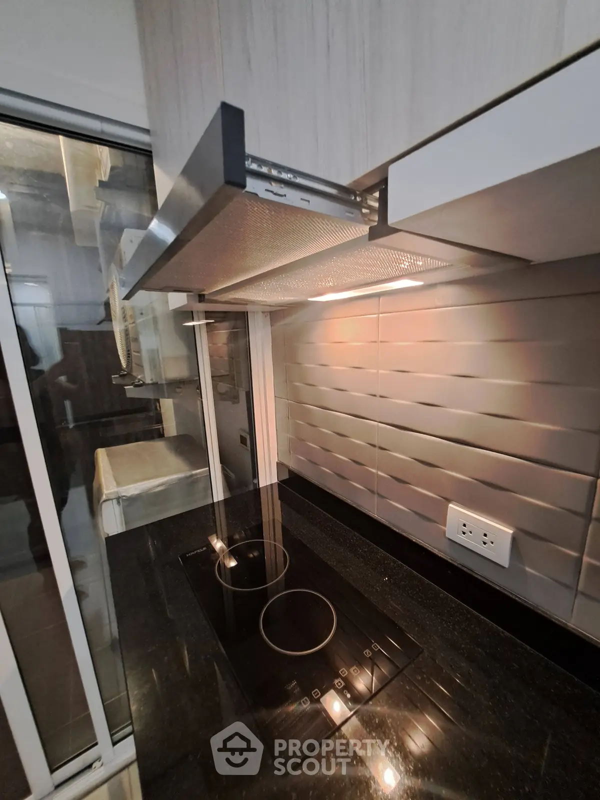 Modern kitchen with sleek electric cooktop and stylish backsplash