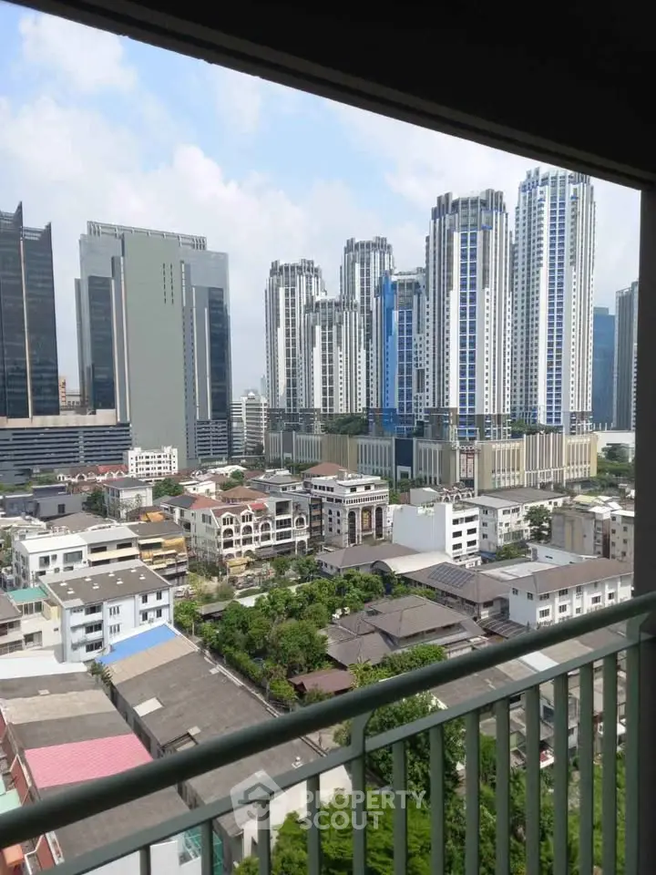 Stunning cityscape view from a high-rise balcony showcasing modern skyscrapers and urban landscape.