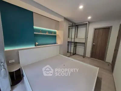 Modern bedroom with built-in storage and stylish lighting in a contemporary apartment.