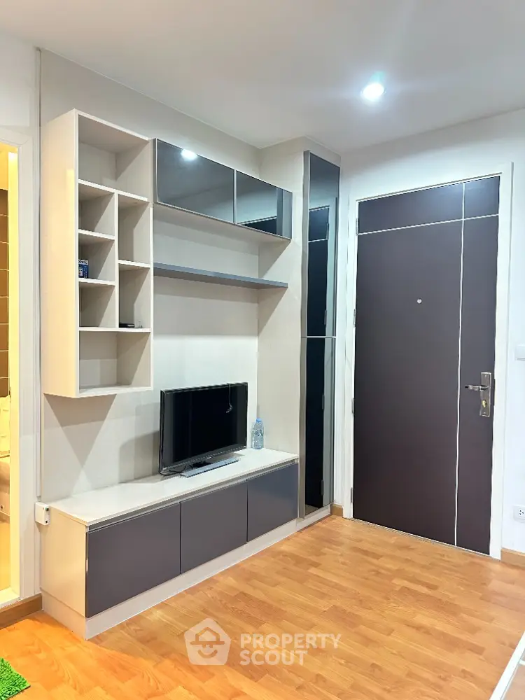 Modern living room with sleek TV unit and wooden flooring