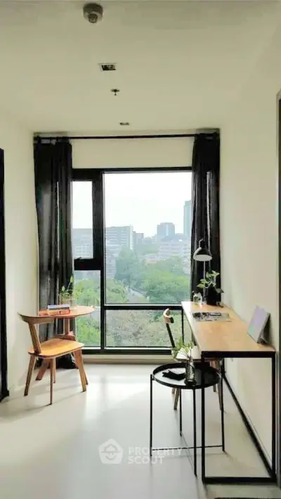 Modern study room with large window offering stunning city view, featuring sleek desk and chair.