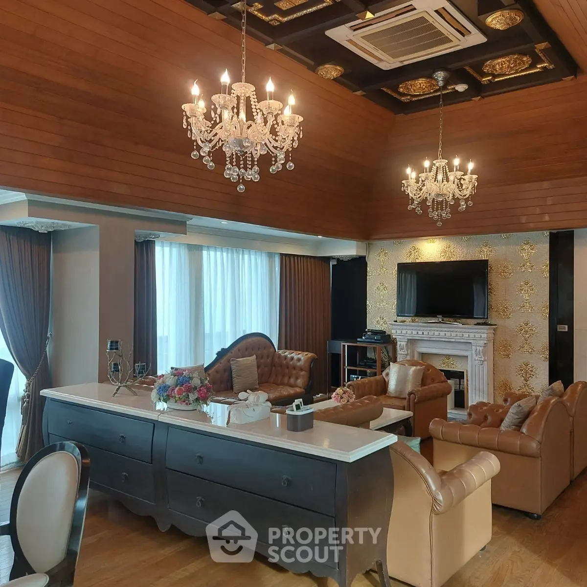Luxurious living room with elegant chandeliers and classic leather furniture