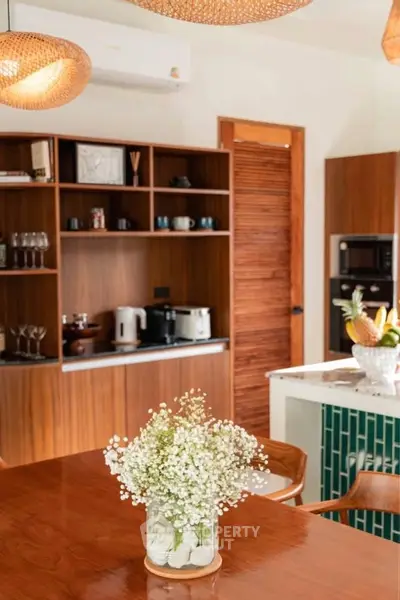 Charming kitchen with wooden cabinetry, modern appliances, and elegant dining setup.