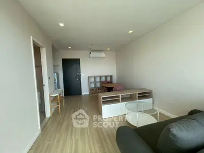 Spacious modern living room with wooden flooring and minimalist furniture