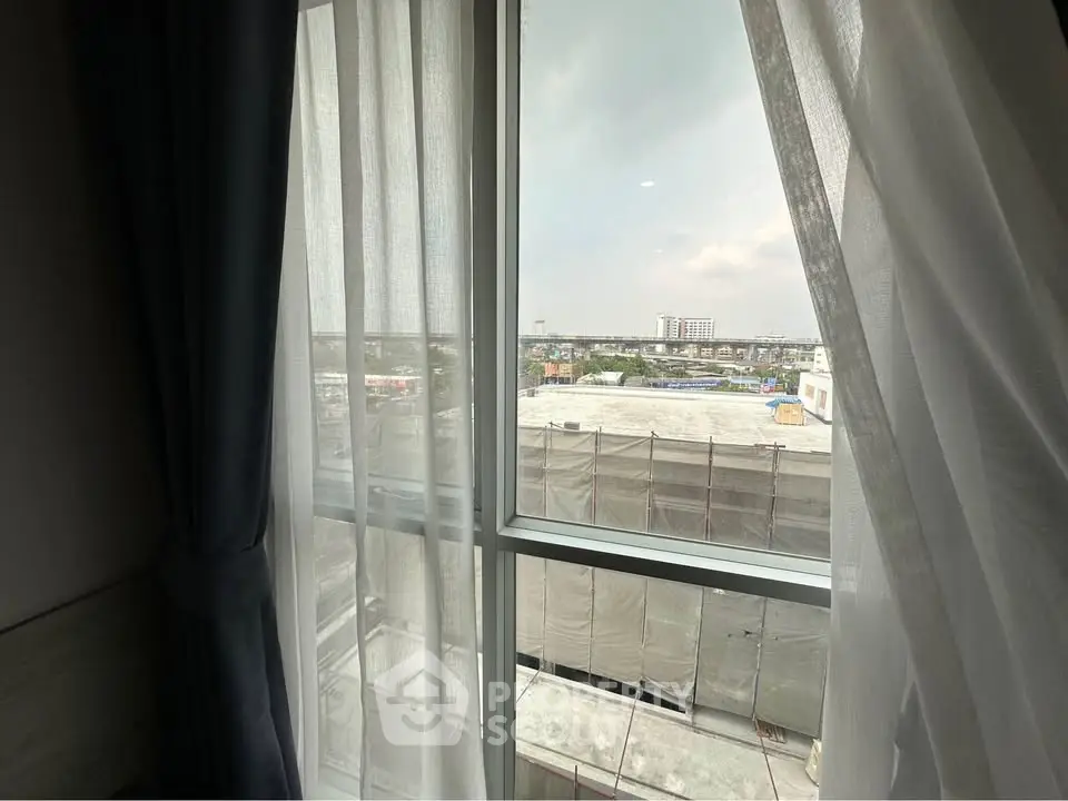 Bright window view from a modern apartment overlooking cityscape, perfect for urban living.