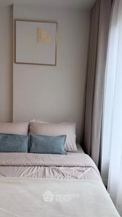 Cozy bedroom with elegant decor and large window for natural light