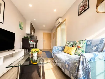 Bright and cozy living room with modern decor and open kitchen layout, perfect for urban living.