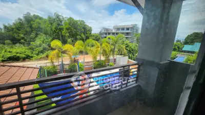 Stunning balcony view with lush greenery and modern architecture.
