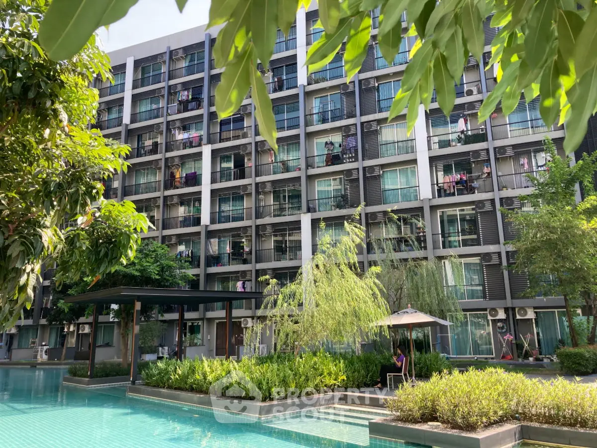 Modern apartment building with lush garden and inviting pool area