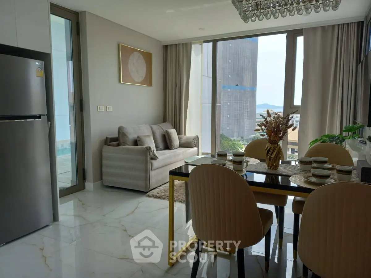 Modern living room with dining area and large windows offering a scenic view.