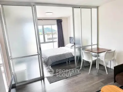 Modern studio apartment with glass partition and mountain view