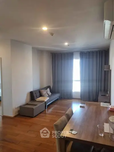 Spacious living room with modern decor and wooden flooring