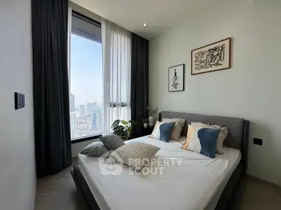 Modern bedroom with city view, stylish decor, and cozy ambiance.
