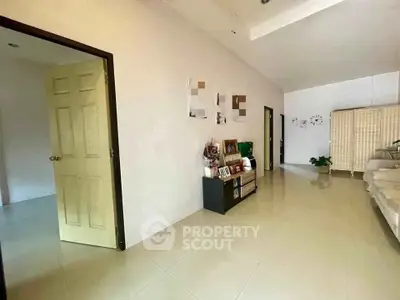 Spacious interior with modern decor and open layout, featuring sleek flooring and neutral tones.