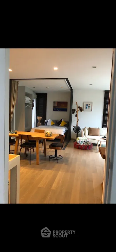 Stylish open-plan living room with modern decor and cozy seating area, perfect for relaxation and entertaining.