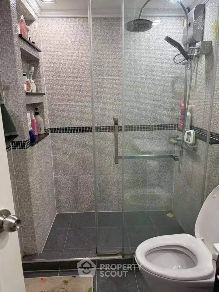 Modern bathroom with glass shower enclosure and sleek tile design