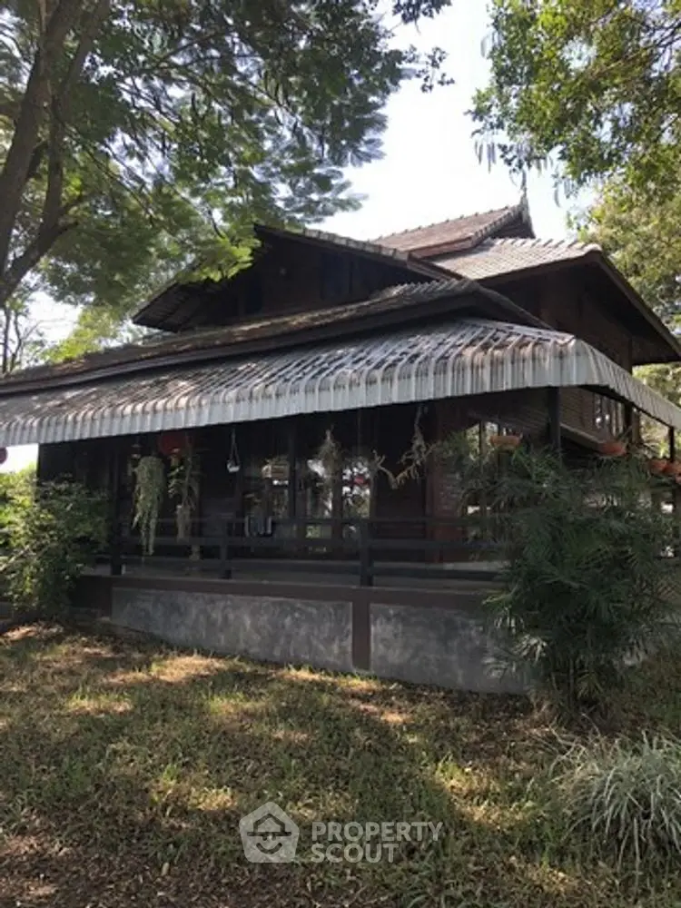 Charming traditional wooden house with lush greenery and serene surroundings.