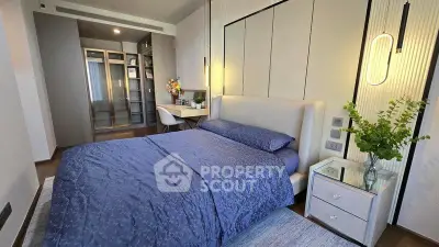 Luxurious bedroom with modern decor and walk-in closet in a stylish apartment.