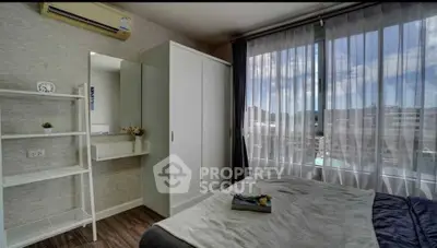Modern bedroom with large window and stylish decor in urban apartment