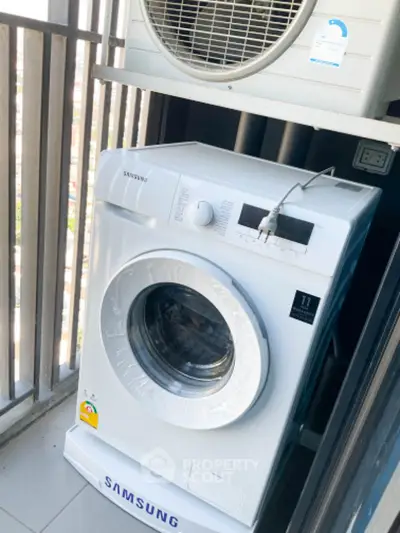 Modern balcony with washing machine and air conditioning unit.