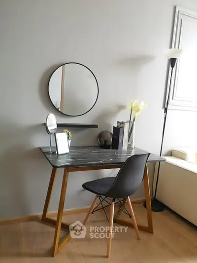 Modern study area with sleek desk and stylish chair in bright room.