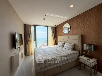 Luxurious bedroom with ocean view, elegant decor, and modern amenities in a high-rise apartment.