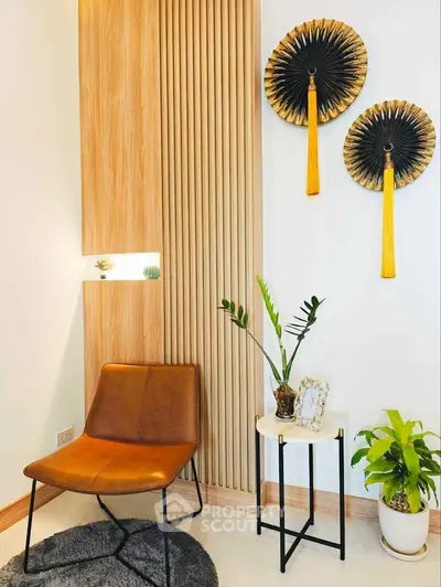Stylish modern living room corner with leather chair and decorative wall art