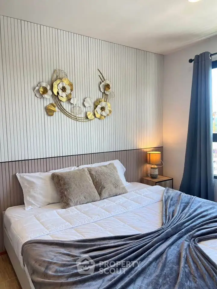 Cozy bedroom with stylish decor and natural light, perfect for relaxation and comfort.