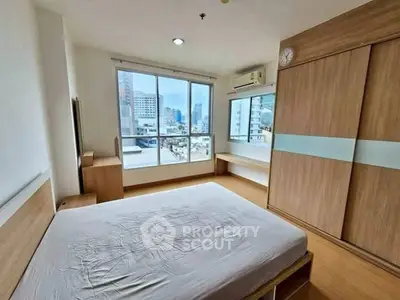 Spacious bedroom with city view and modern wooden furniture