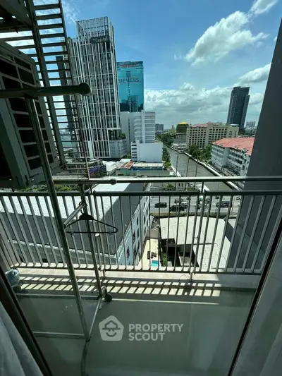 Stunning city view from a high-rise balcony with modern urban skyline.