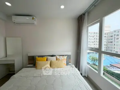 Bright bedroom with large windows and pool view in modern apartment
