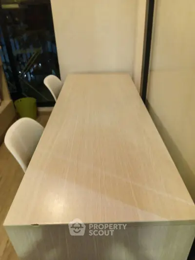 Modern study area with sleek wooden desk and chairs, perfect for productivity and focus.