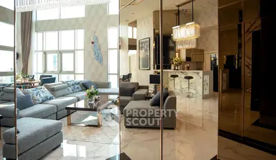 Luxurious modern living room with elegant decor and spacious seating area, featuring high ceilings and large windows.