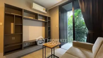 Modern living room with built-in shelving and balcony view, featuring sleek design and natural light.