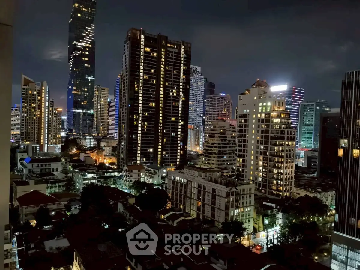 Stunning city skyline view with illuminated skyscrapers at night, perfect for urban living enthusiasts.