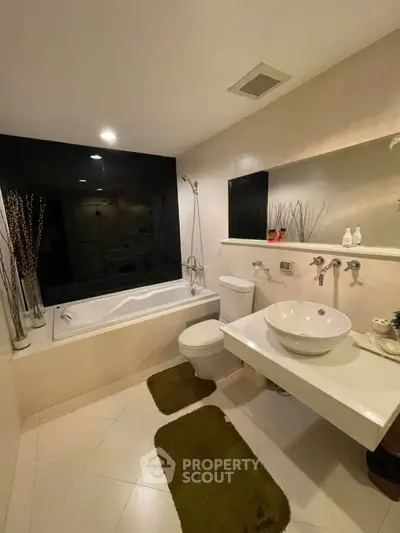 Modern bathroom with sleek design, featuring a bathtub and stylish fixtures, perfect for relaxation.
