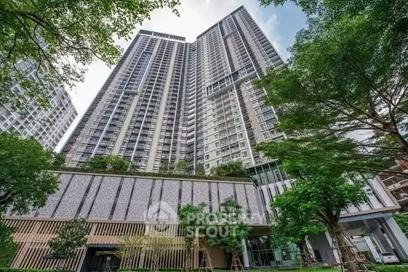 Stunning high-rise residential building with lush greenery and modern architecture.