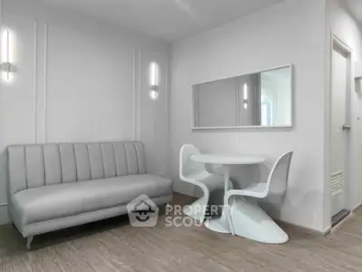 Modern minimalist living room with sleek sofa and stylish dining set