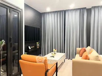 Modern living room with sleek furniture and floor-to-ceiling curtains