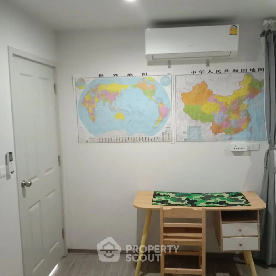 Cozy study room with wall maps and modern air conditioning unit.