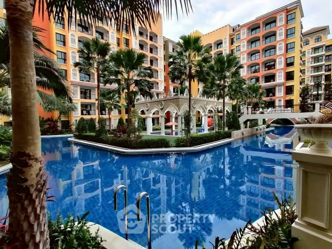Luxurious residential complex with stunning pool and elegant architecture.