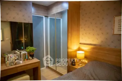 Cozy bedroom with mirrored closet and warm lighting, perfect for relaxation.