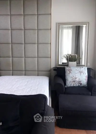 Cozy bedroom with elegant decor and plush seating area