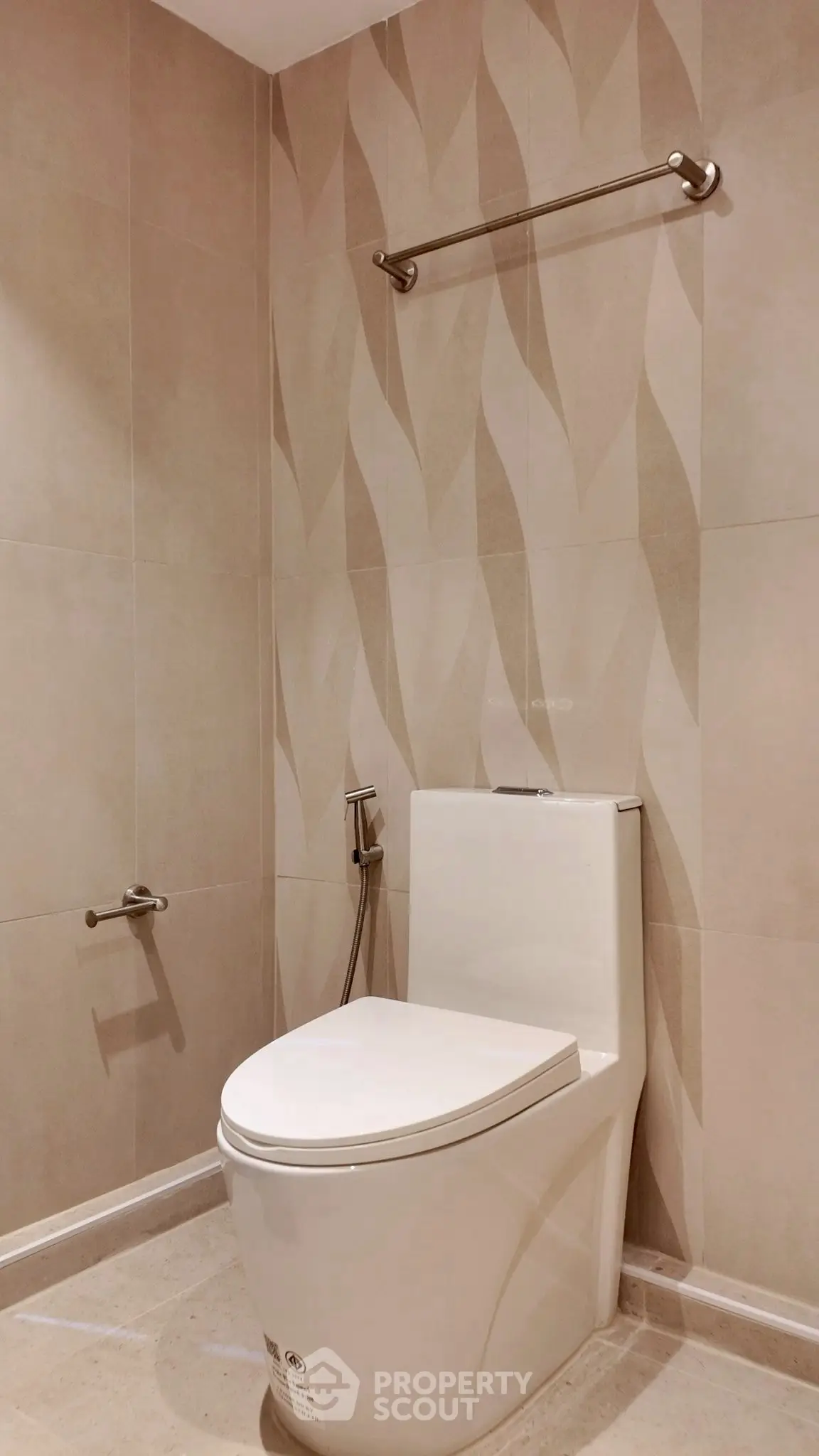 Modern bathroom with sleek toilet and stylish wall tiles
