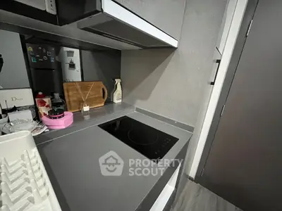 Modern kitchen with sleek countertop and electric stove, perfect for urban living.