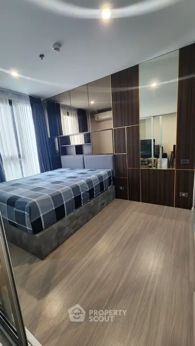 Modern bedroom with stylish decor and large windows for natural light