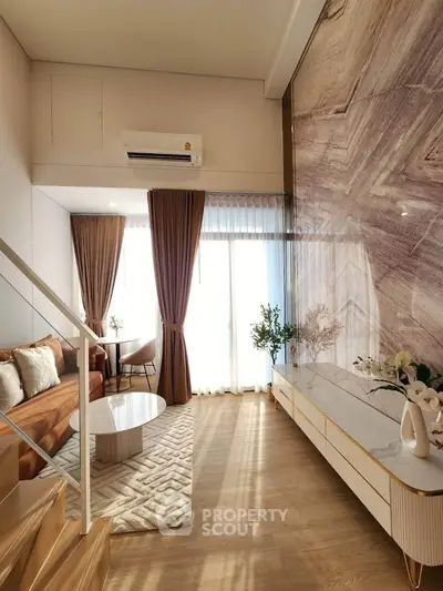 Luxurious living room with high ceilings, elegant decor, and natural light in modern apartment.