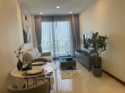 Modern living room with elegant decor and large window offering natural light.