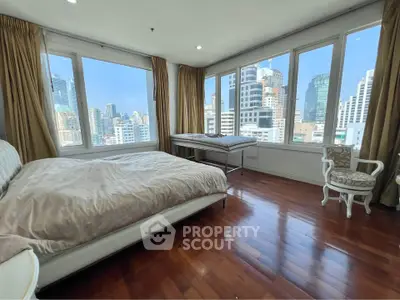 Luxurious bedroom with panoramic city views and elegant furnishings