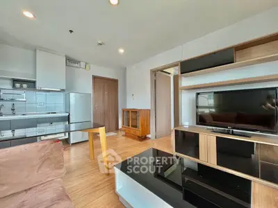 Modern living room with sleek furniture and open kitchen layout in a stylish apartment.